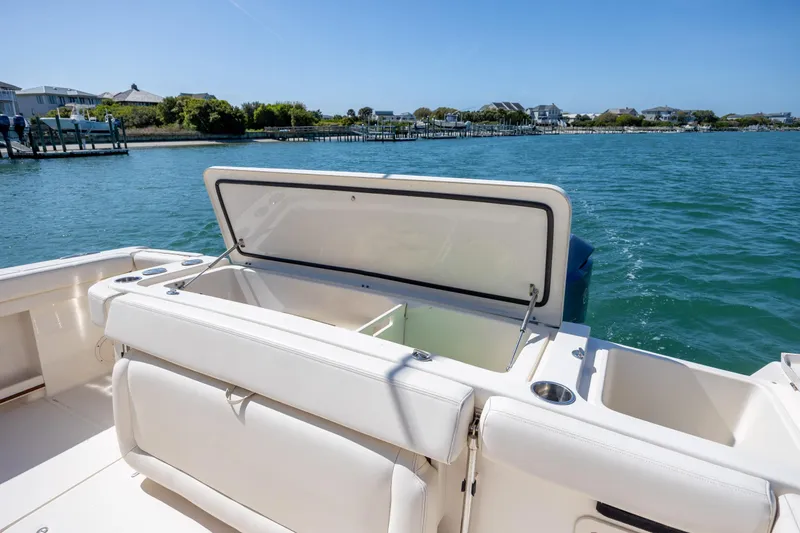 Slide: The Image of 2017 Grady-White Canyon 376 boat with open storage compartment on calm water. - 18