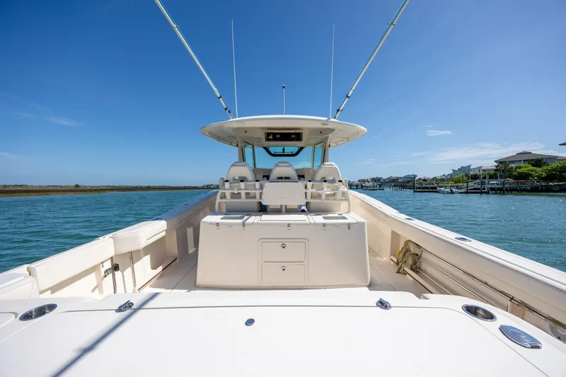 Slide: The Image of 2017 Grady-White Canyon 376 boat on calm water under clear blue sky. - 21