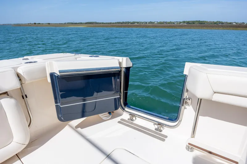 Slide: The Image of 2017 Grady-White Canyon 376 boat interior with open transom door, overlooking calm water. - 23