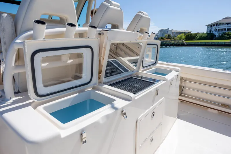 Slide: The Image of 2017 Grady-White Canyon 376 boat interior with open storage compartments by the water. - 24