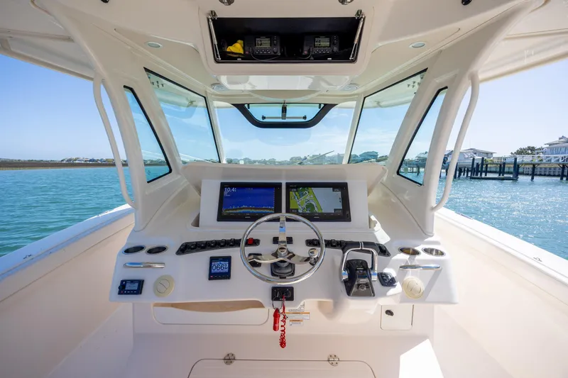 Slide: The Image of Helm of 2017 Grady-White Canyon 376 boat with navigation screens and controls. - 25
