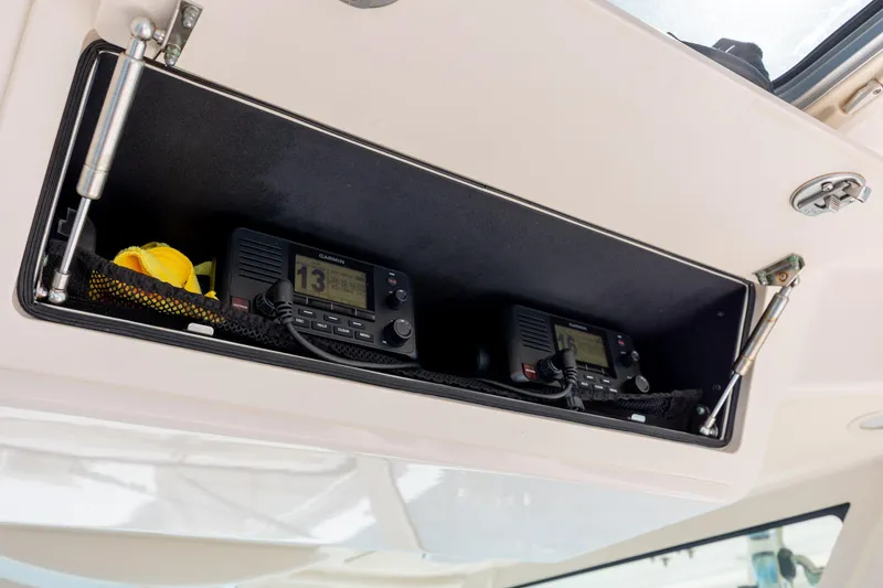 Slide: The Image of 2017 Grady-White Canyon 376 boat storage compartment with Garmin marine radios. - 27