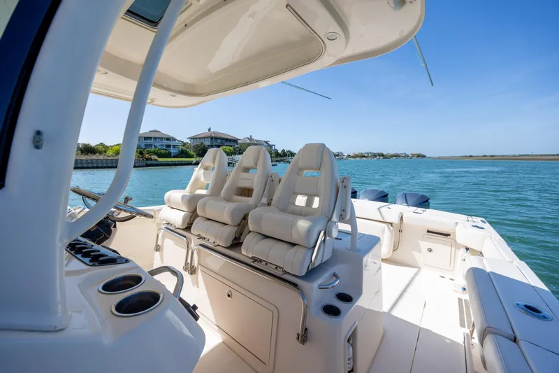 Slide: The Image of 2017 Grady-White Canyon 376 boat interior with luxurious seating on a sunny day. - 28