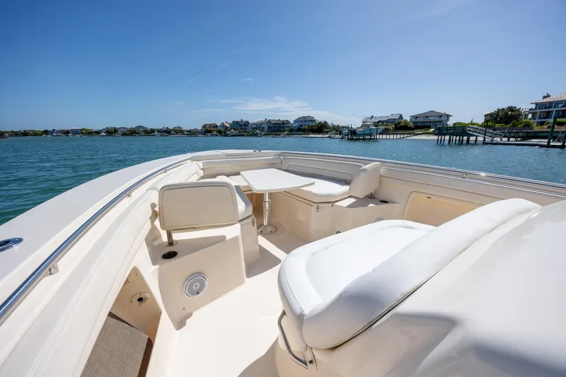 Slide: The Image of 2017 Grady-White Canyon 376 boat interior with seating and table on calm water. - 30