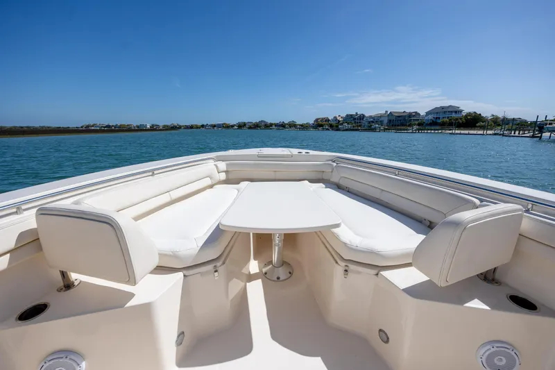 Slide: The Image of 2017 Grady-White Canyon 376 boat interior with seating and table on calm water. - 31