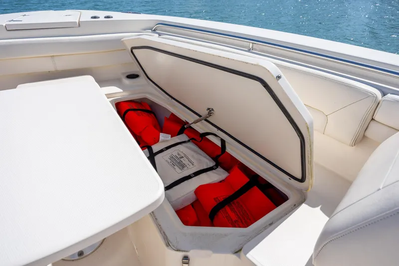 Slide: The Image of Storage compartment with life jackets on a 2017 Grady-White Canyon 376 boat. - 35