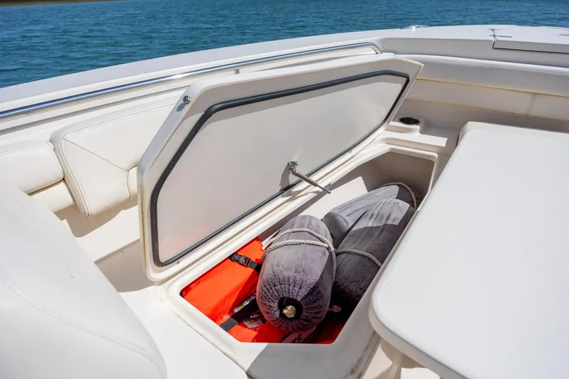 Slide: The Image of 2017 Grady-White Canyon 376 boat storage compartment with life jackets and fenders. - 36