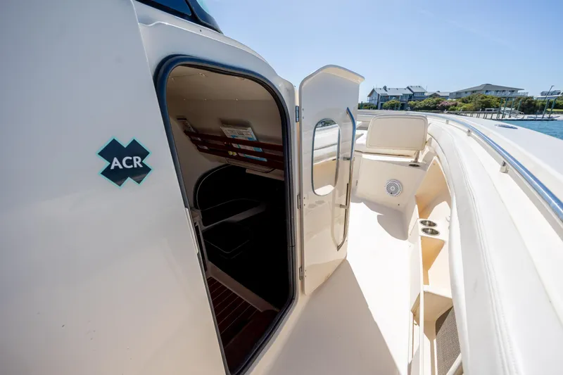 Slide: The Image of 2017 Grady-White Canyon 376 boat interior with open cabin door, dockside view. - 39