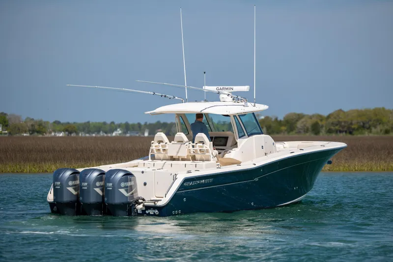 Slide: The Image of 2017 Grady-White Canyon 376 boat with four Yamaha engines on a calm waterway. - 4