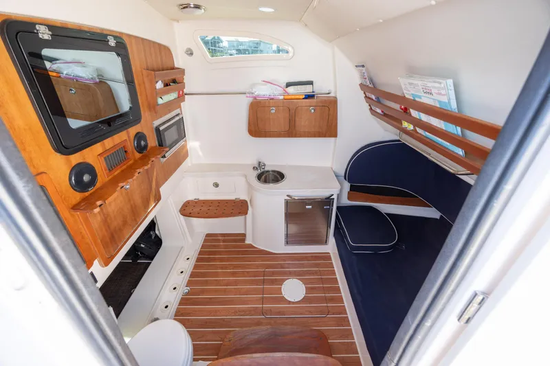 Slide: The Image of 2017 Grady-White Canyon 376 cabin interior with wood accents and seating area. - 40