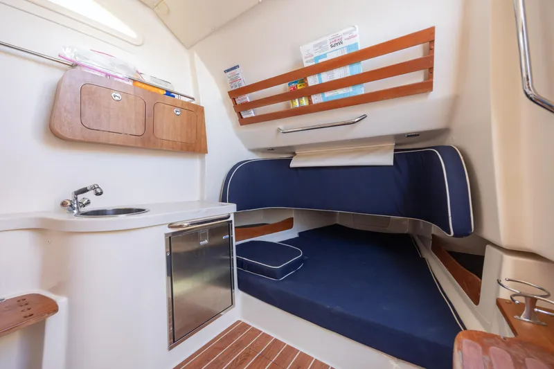 Slide: The Image of 2017 Grady-White Canyon 376 cabin interior with sink, storage, and blue cushioned seating. - 41