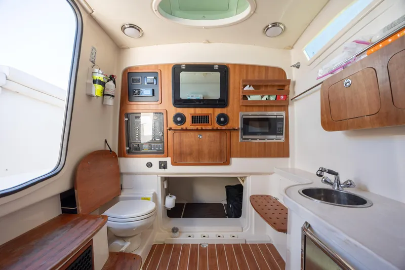 Slide: The Image of 2017 Grady-White Canyon 376 cabin interior with wood accents, sink, and appliances. - 42