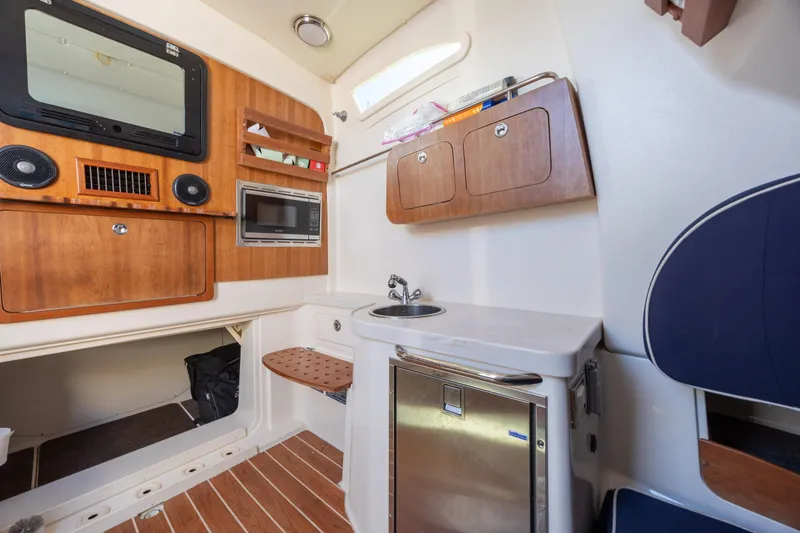 Slide: The Image of Interior of 2017 Grady-White Canyon 376 boat with kitchenette and storage cabinets. - 43