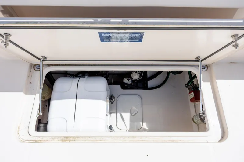 Slide: The Image of Open storage compartment on 2017 Grady-White Canyon 376 boat, showing interior equipment. - 46