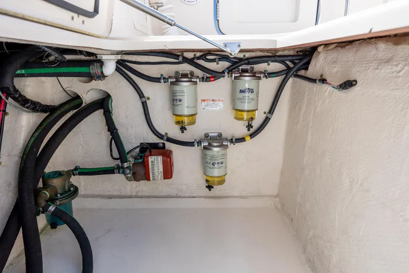 Slide: The Image of Engine compartment of 2017 Grady-White Canyon 376 with fuel filters and hoses. - 47