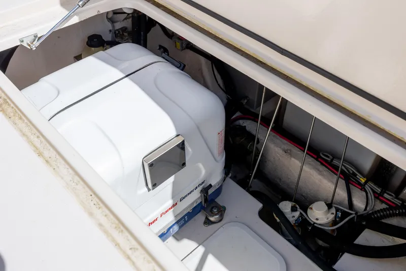 Slide: The Image of 2017 Grady-White Canyon 376 boat generator compartment with wiring and components. - 48