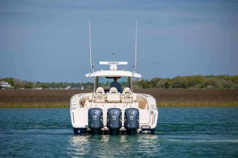 Slide: The Image of 2017 Grady-White Canyon 376 boat with triple Yamaha engines on calm water. - 5