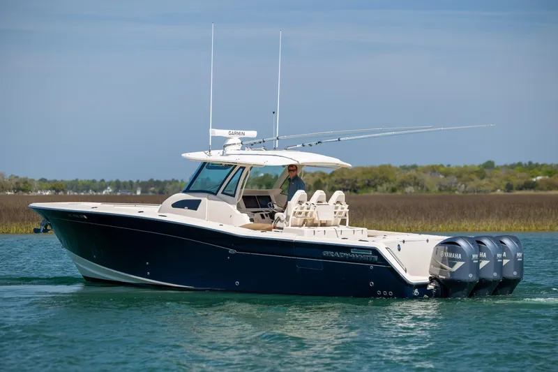 Slide: The Image of 2017 Grady-White Canyon 376 boat with triple Yamaha engines on calm water. - 6