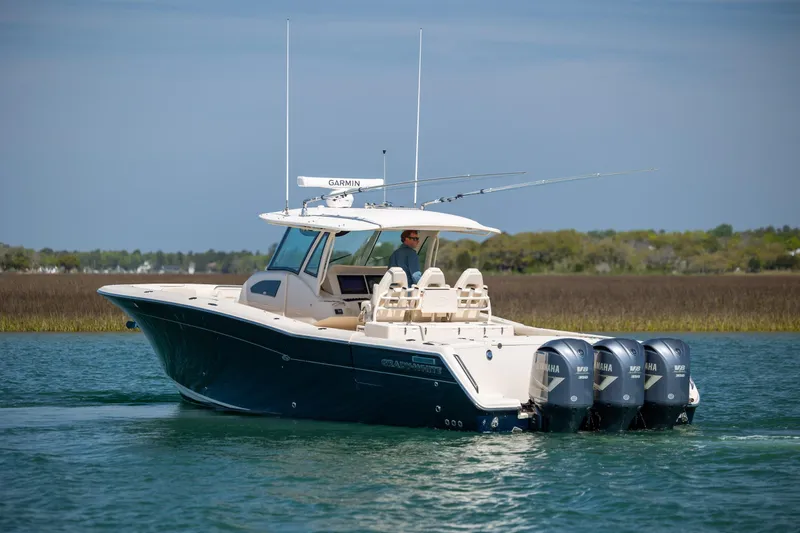 Slide: The Image of 2017 Grady-White Canyon 376 boat with four Yamaha engines on calm water. - 7