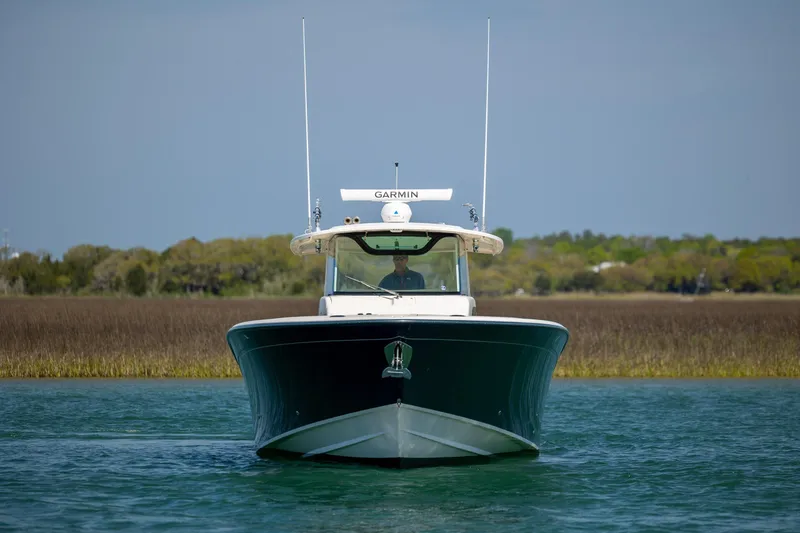 Slide: The Image of 2017 Grady-White Canyon 376 boat on water, front view with Garmin equipment. - 8