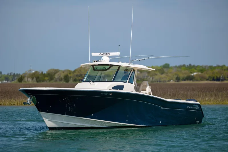 Slide: The Image of 2017 Grady-White Canyon 376 boat on calm water with Garmin equipment. - 9
