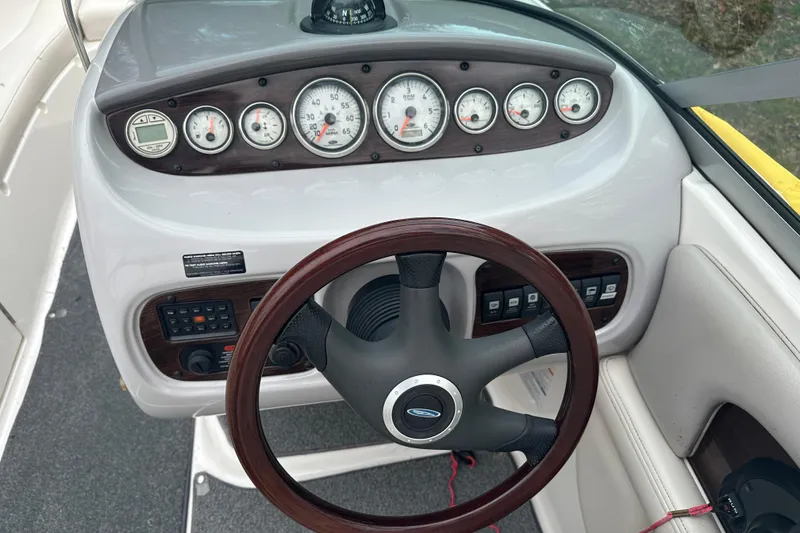 Slide: The Image of Dashboard of a 2005 Chaparral Sunesta 216 boat with gauges and steering wheel. - 10