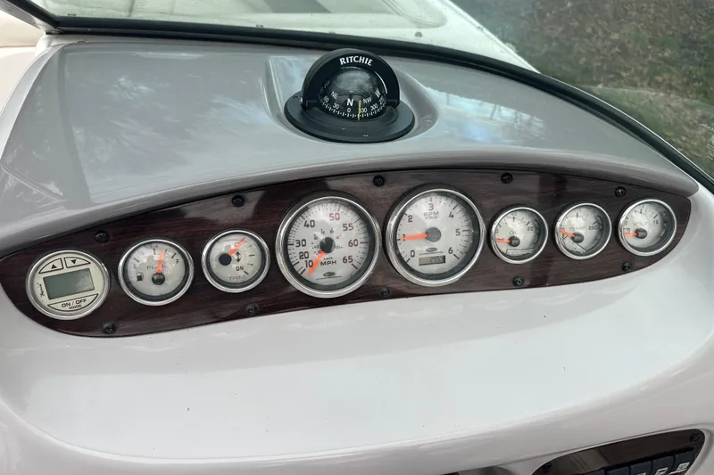 Slide: The Image of Dashboard of a 2005 Chaparral Sunesta 216 boat with gauges and compass. - 11