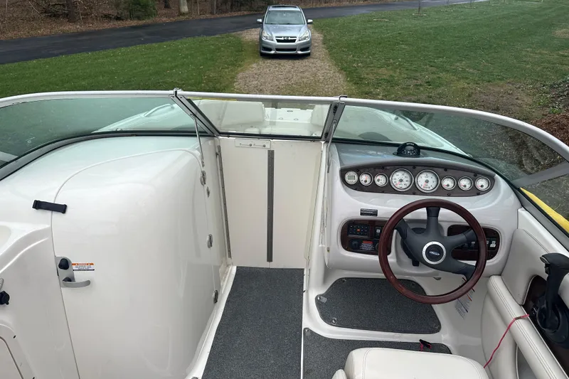 Slide: The Image of 2005 Chaparral Sunesta 216 boat interior with steering wheel and dashboard controls. - 13