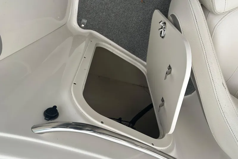 Slide: The Image of Storage compartment in a 2005 Chaparral Sunesta 216 boat, open with visible interior. - 14