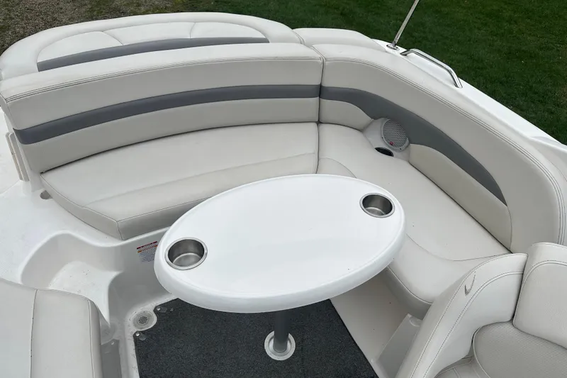 Slide: The Image of 2005 Chaparral Sunesta 216 boat interior with white seating and oval table. - 15