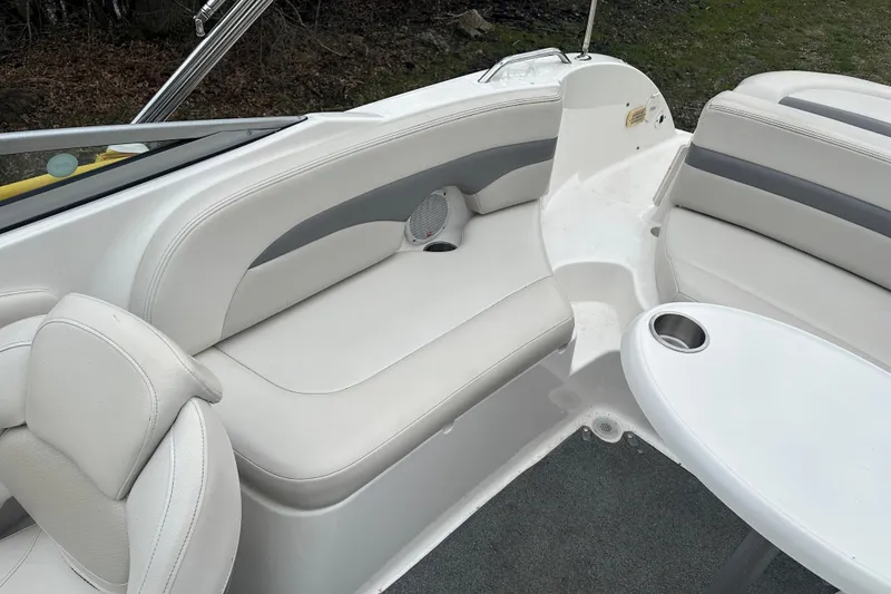Slide: The Image of 2005 Chaparral Sunesta 216 boat interior with white seating and table. - 16