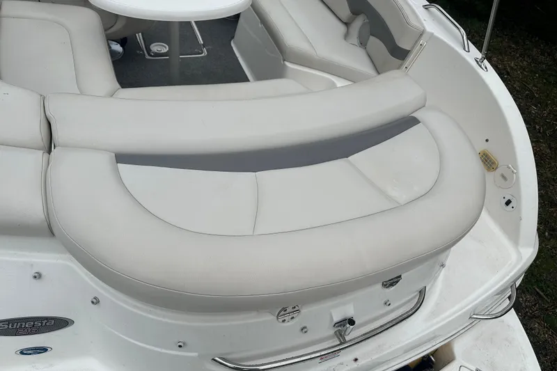 Slide: The Image of 2005 Chaparral Sunesta 216 boat interior with white cushioned seating and table. - 17