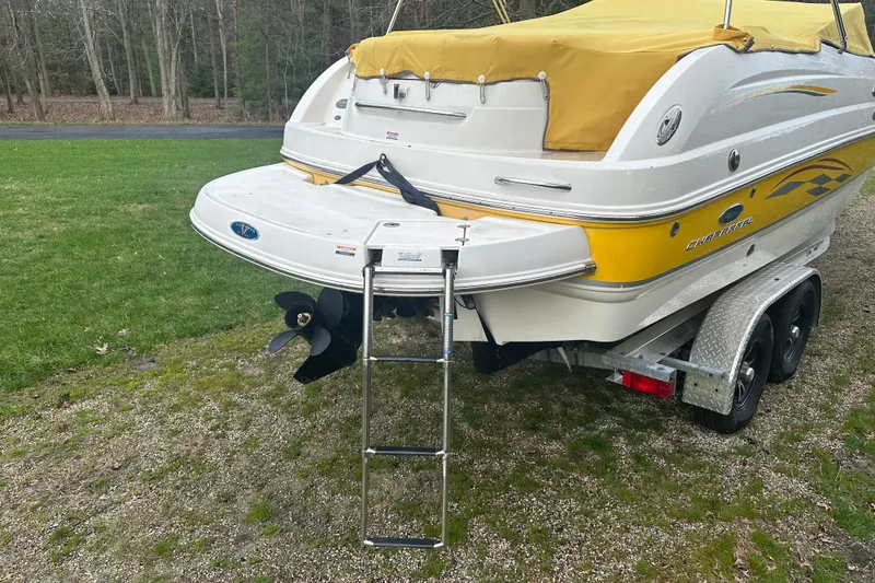 Slide: The Image of 2005 Chaparral Sunesta 216 boat with yellow cover and trailer, rear view. - 3
