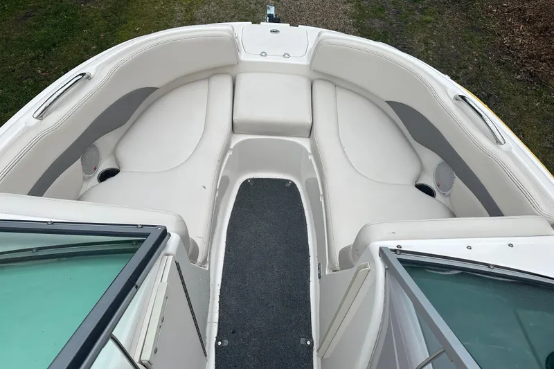 Slide: The Image of 2005 Chaparral Sunesta 216 boat interior with white seating and carpeted floor. - 4