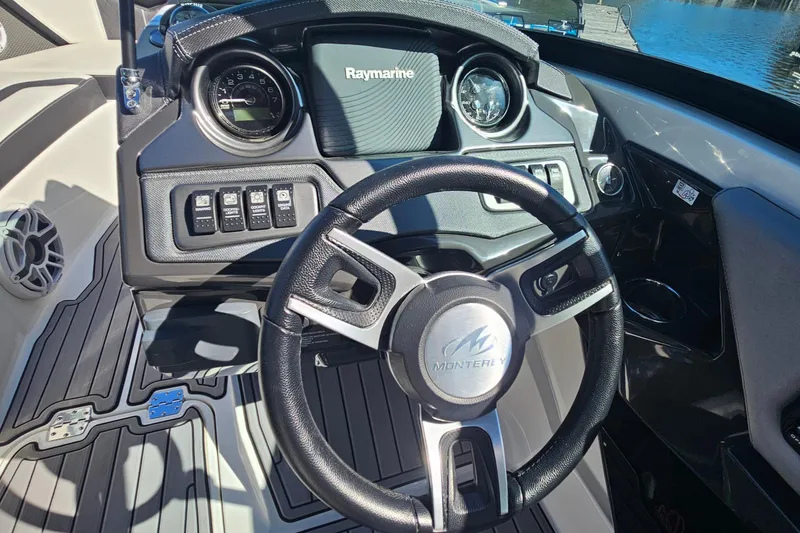 Slide: The Image of 2017 Monterey 238SS Super Sport boat dashboard with steering wheel and control panel. - 12