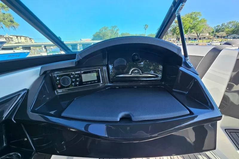 Slide: The Image of Dashboard of 2017 Monterey 238SS Super Sport boat with audio system and storage. - 13