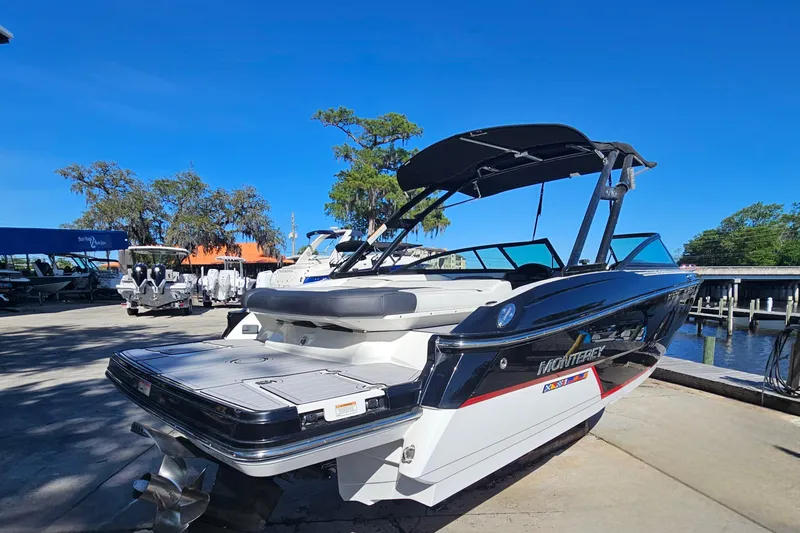 Slide: The Image of 2017 Monterey 238SS Super Sport boat docked under clear blue sky. - 2