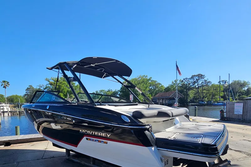 Slide: The Image of 2017 Monterey 238SS Super Sport boat docked by a scenic waterfront. - 3