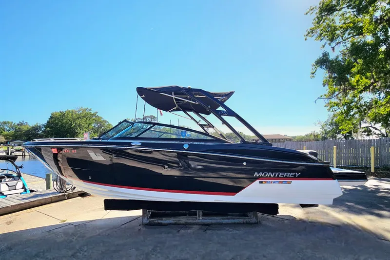 Slide: The Image of 2017 Monterey 238SS Super Sport boat docked under clear blue sky. - 4