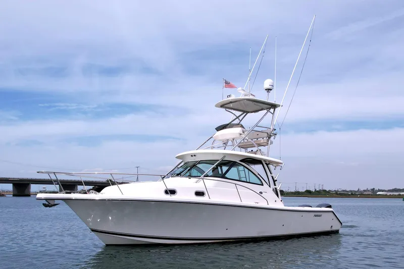 The Image of 2012 Pursuit OS 345 Offshore boat on calm water under a clear sky. - 0