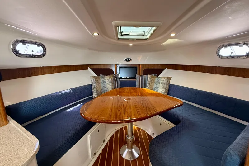 Slide: The Image of Luxurious interior of 2012 Pursuit OS 345 Offshore boat with elegant seating and wooden table. - 10