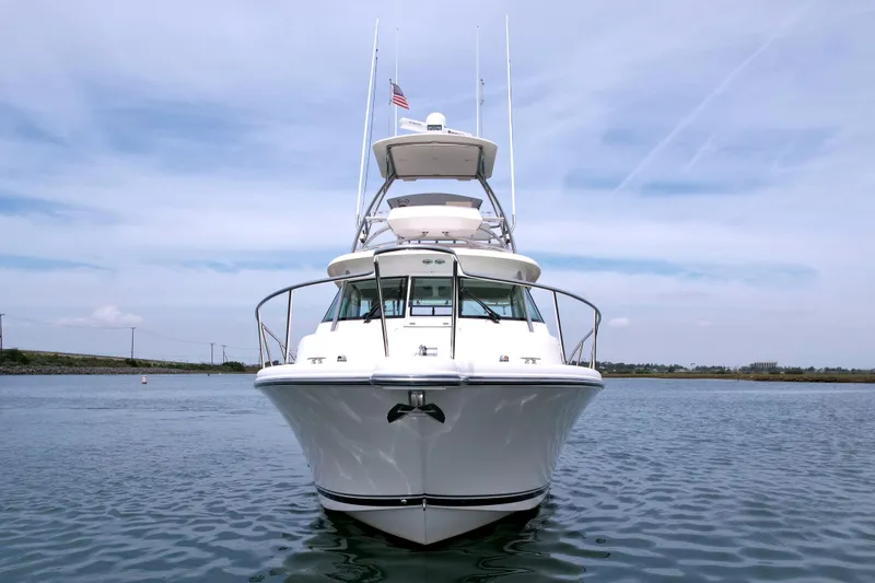 Slide: The Image of 2012 Pursuit OS 345 Offshore boat on calm water, front view with clear sky. - 2