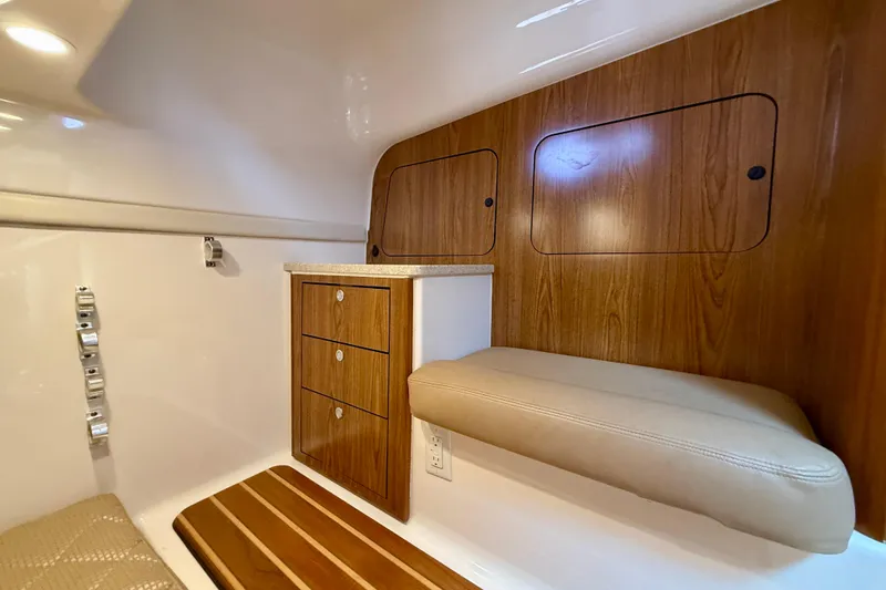 Slide: The Image of Interior of 2012 Pursuit OS 345 Offshore boat with wood cabinetry and cushioned seating. - 32