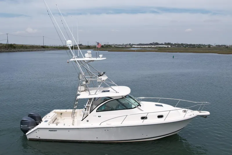 Slide: The Image of 2012 Pursuit OS 345 Offshore boat on calm water, featuring dual Yamaha engines. - 4