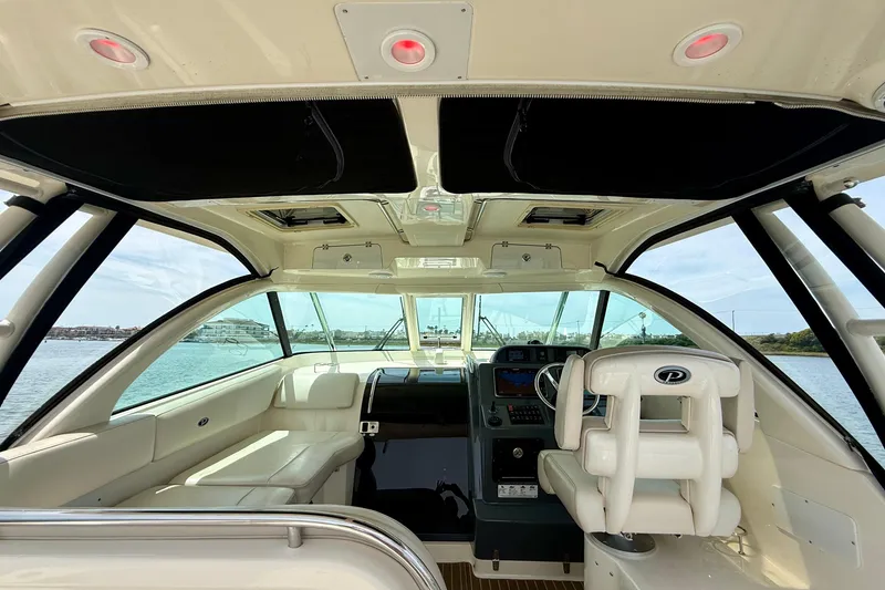Slide: The Image of Interior view of 2012 Pursuit OS 345 Offshore boat, featuring helm and seating area. - 40