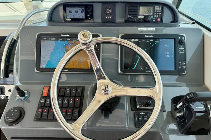 Slide: The Image of 2012 Pursuit OS 345 Offshore helm with navigation screens and controls. - 42