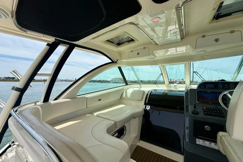 Slide: The Image of Interior of 2012 Pursuit OS 345 Offshore boat with luxurious seating and navigation controls. - 52