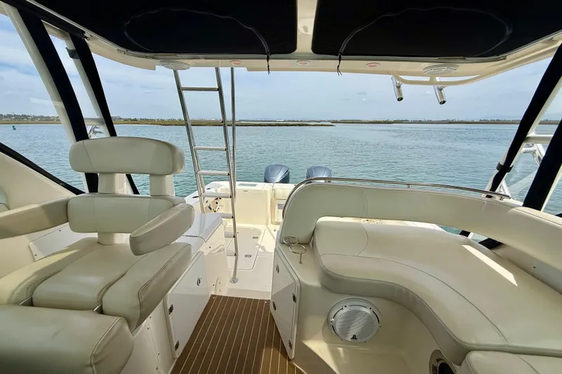 Slide: The Image of Interior view of 2012 Pursuit OS 345 Offshore boat with seating and ocean backdrop. - 53