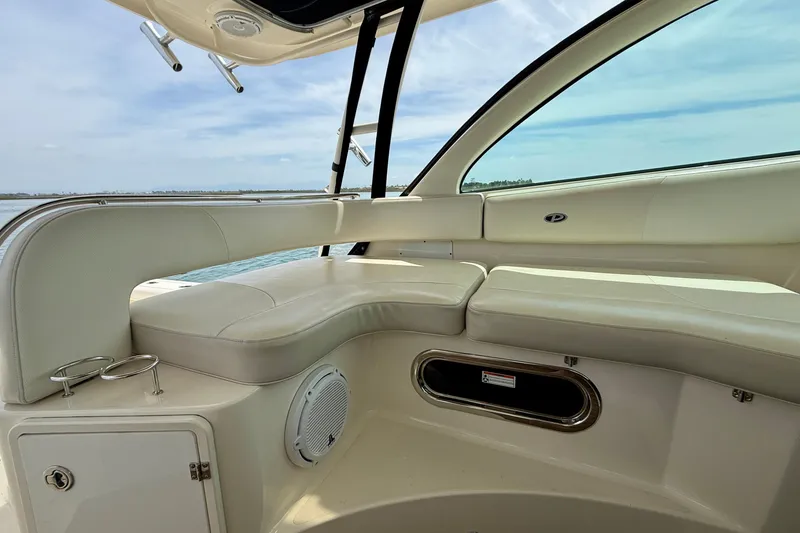 Slide: The Image of Interior view of 2012 Pursuit OS 345 Offshore boat with white seating and ocean backdrop. - 55
