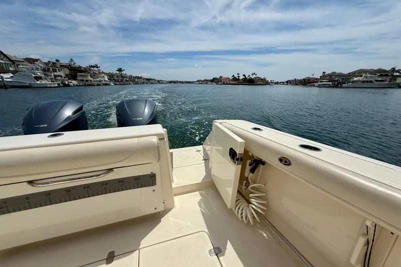 Slide: The Image of 2012 Pursuit OS 345 Offshore boat cruising in a scenic coastal waterway. - 58